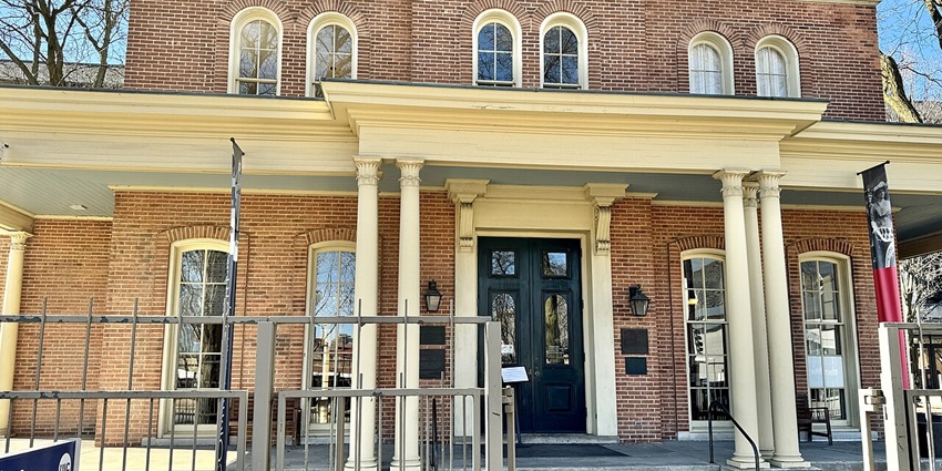 Exterior of the Jane Addams Hull-House Museum with long flags hanging on the front.