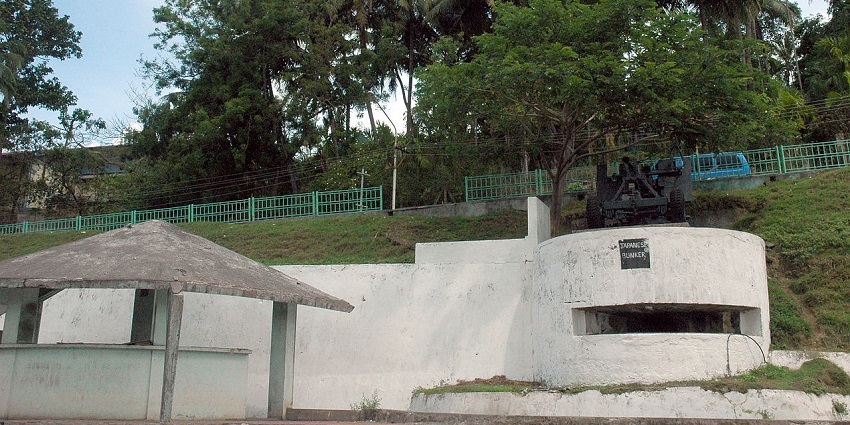 Historic Japanese Bunker in Port Blair surrounded by lush greenery and blue skies.
