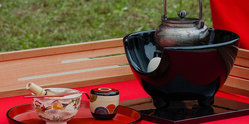 A porcelain Japanese tea set with a teapot and cups featuring subtle blue floral patterns.