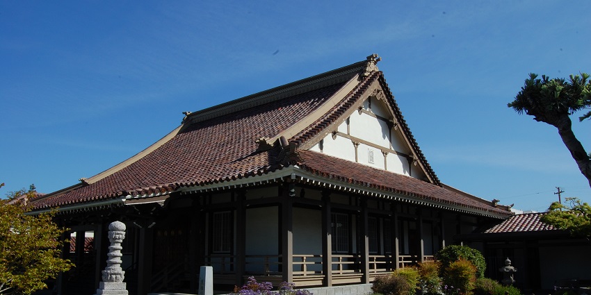 Buddhist temple in Japantown with traditional Japanese architecture and small plants.