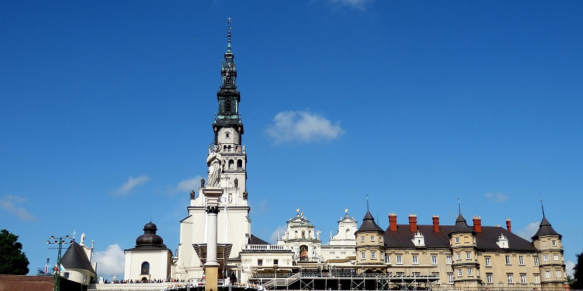 Jasna Góra Monastery with a detailed statue on a pillar and tall traditional buildings