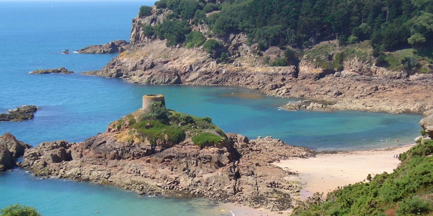 A coastal view of the Jersey islands in Channel Islands with rocky cliffs and blue waters