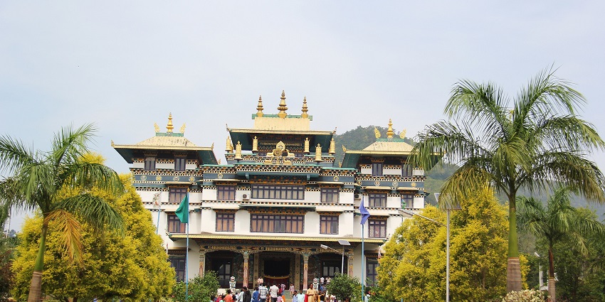 Jirang monastery with traditional architecture, people visiting, and stairs leading to the monastery
