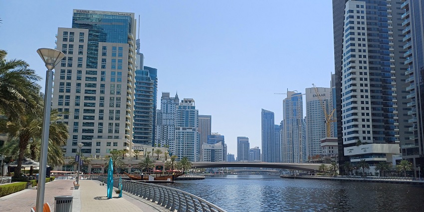 Scenic fitness trail lined with yachts, palm trees, and refreshing sea breeze.