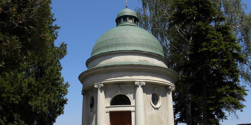 Heiligeneich Mausoleum with stone walls surrounded by lush greenery and clear skies.