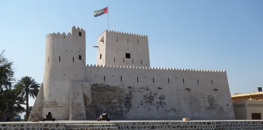 Kalba fort with traditional architecture, old small cannons and the flag on the top.