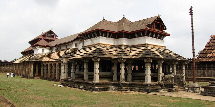 Side view of the historic Kambada Temple, with intricate stone architecture and traditional Indian temple design.