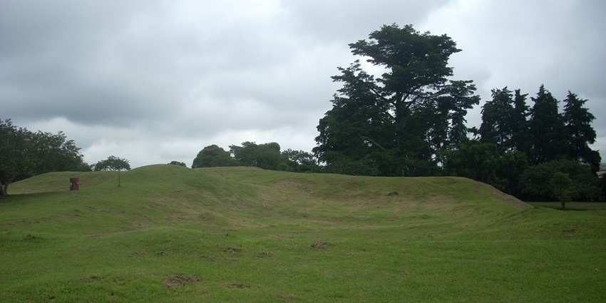 Excavated mounds of Kaminaljuyú amid Guatemala City sprawl.