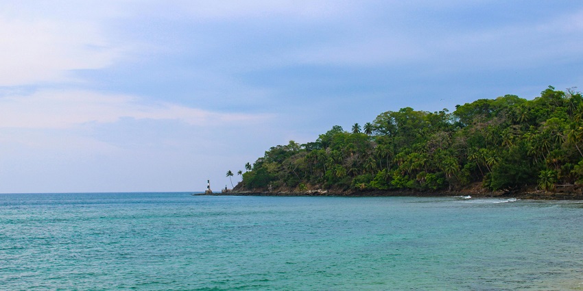 Peaceful shoreline of Karmatang Beach with soft sand and gentle ocean waves
