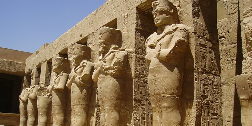 Expansive temple complex in Luxor with towering columns, hieroglyph-covered walls, and sacred obelisks, one of the monuments in Egypt.