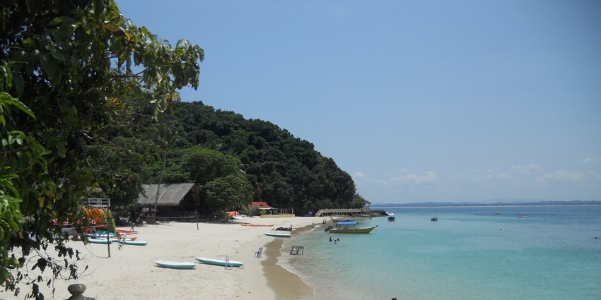 Kayak through limestone cliffs and turquoise waters in secluded Kapa Island lagoon.