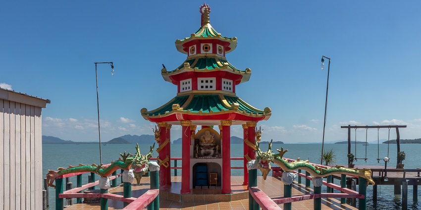 Ko Lanta in Thailand with a unique pier, vibrant architecture, two dragons, and street lamps
