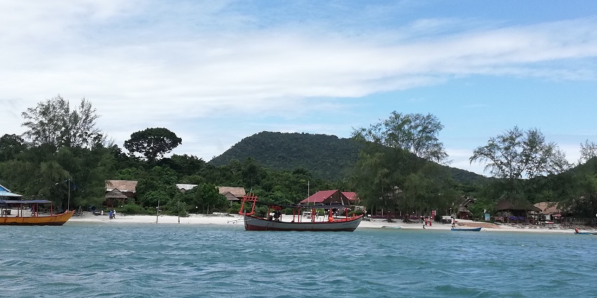 Panoramic view of lush green hills and tranquil blue waters along the coastline of the islands in Cambodia.