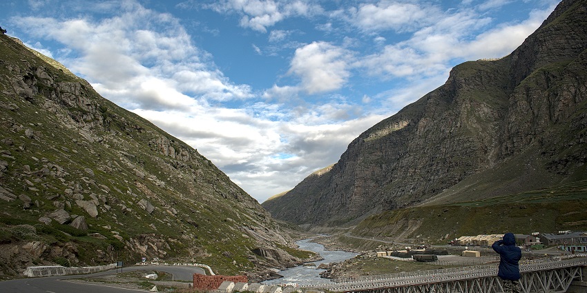 Chandra river flows past Koksar Village with a few houses scattered in the village.