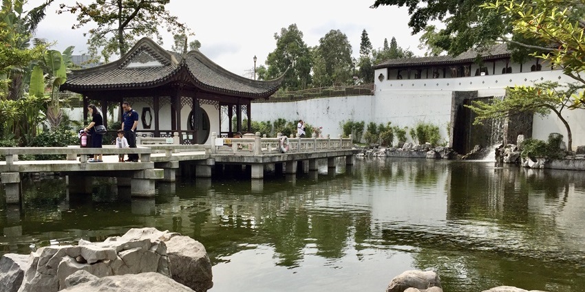 Traditional Chinese pavilion in a landscaped garden at Kowloon Walled City Park, one of the top historical places in Hong Kong.