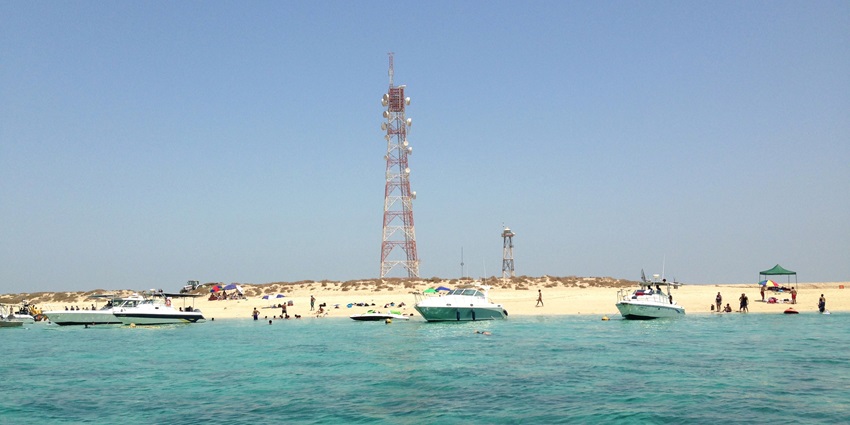 Turquoise waters and circular white sand beach of uninhabited Kubbar Island, one of the top islands in Kuwait.