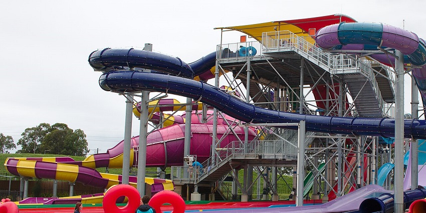 Colourful water slides twist and turn at Kunduchi Wet’n’Wild, with excited visitors enjoying thrilling rides under sunny skies.
