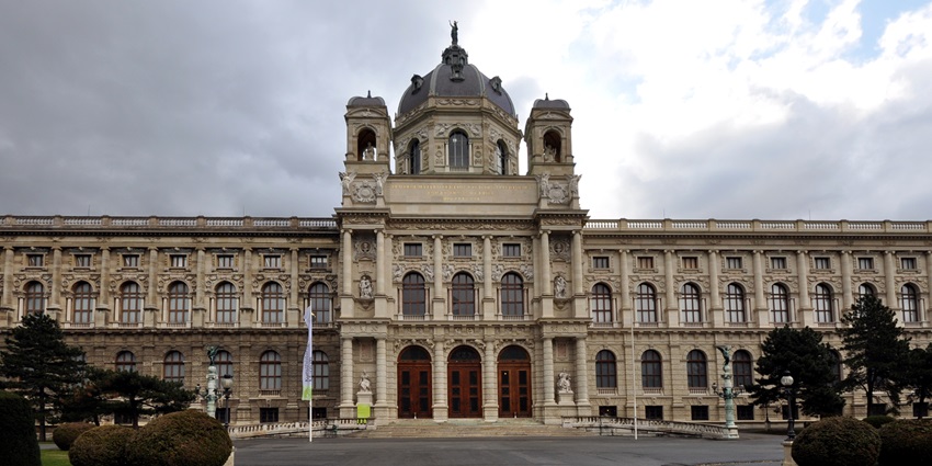 The exterior of the Kunsthistorisches Museum Vienna features detailed sculptures, decorative railings, and elegant architectural design.
