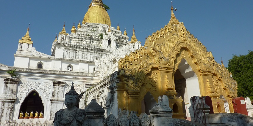 A large golden stupa with intricate carvings, one of the best historical places in Yangon.