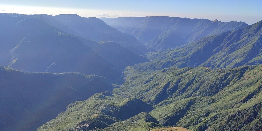 From the viewpoint of Laitlum canyons with hills covered in the greenery of Shillong.