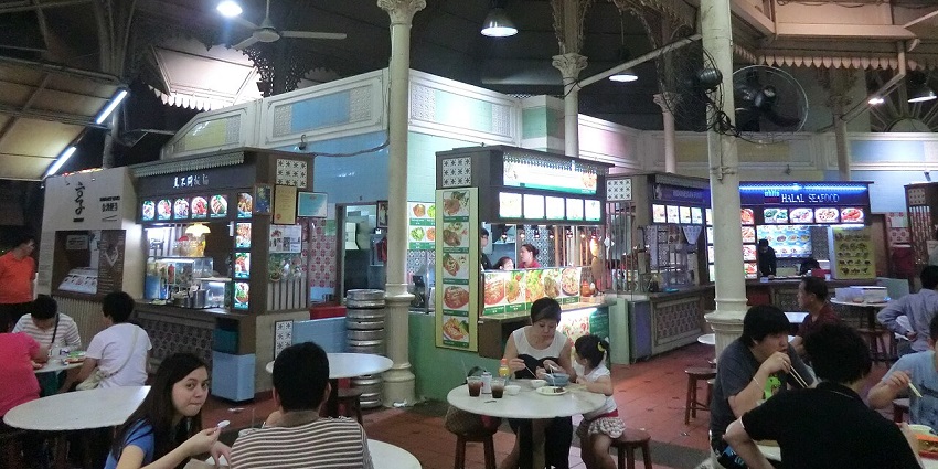 The vibrant scene at Lau Pa Sat Festival Market with food stalls and a lively atmosphere.
