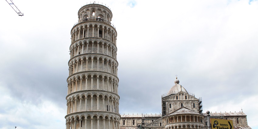The Leaning Tower of Pisa in Italy, with detailed white architecture and a cathedral in the background