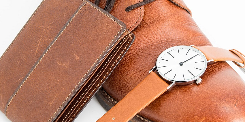 A brown leather shoe, wallet, and wristwatch, on the list of what to buy in Pondicherry.