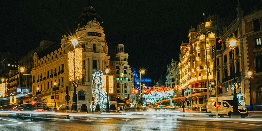 A brightly lit souvenir kiosk against the evening sky, it is what is Madrid famous for.