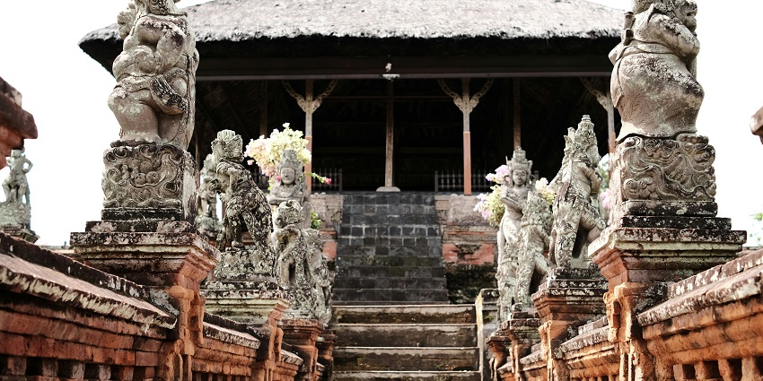 Traditional Balinese architecture at Lempad House Museum in Ubud surrounded by stone carvings and greenery