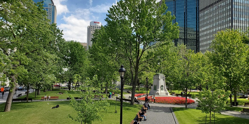 Peaceful park scene in Quebec City with families and seniors, showing what is the safest city in Canada.