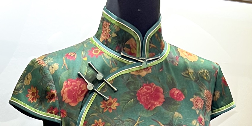 Limited-edition silk qipao featuring elegant embroidery and a form-fitting design.