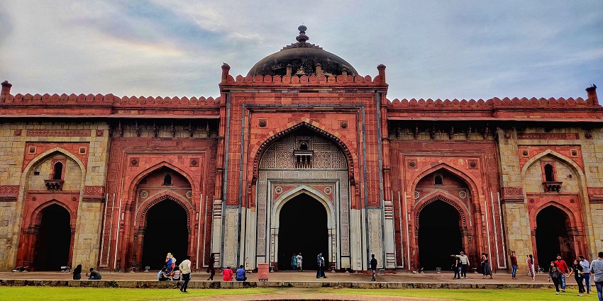 Ancient stone walls and gateways of Purana Quila are surrounded by greenery in Delhi
