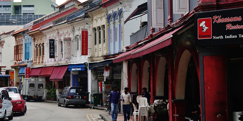 Street in Little India, with colourful buildings and bustling street life with people, one of the best places to visit in Singapore in September.

