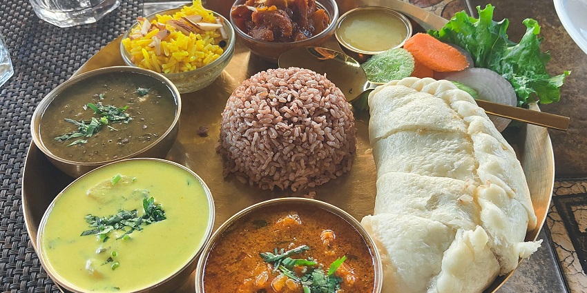 A plate of authentic Himachali thali with siddhu, red rice and local delicacies