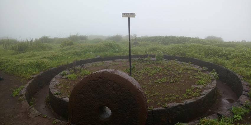 An image with the scenic view of Kenjalgad Fort perched on a hilltop in the Western Ghats.