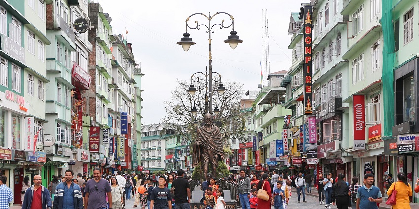 Lively view of MG Marg in Gangtok with people walking, shops, and decorative lamp posts, one of the places to visit in Gangtok in March.