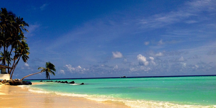 Tropical island town with bright blue waters, sandy beaches.