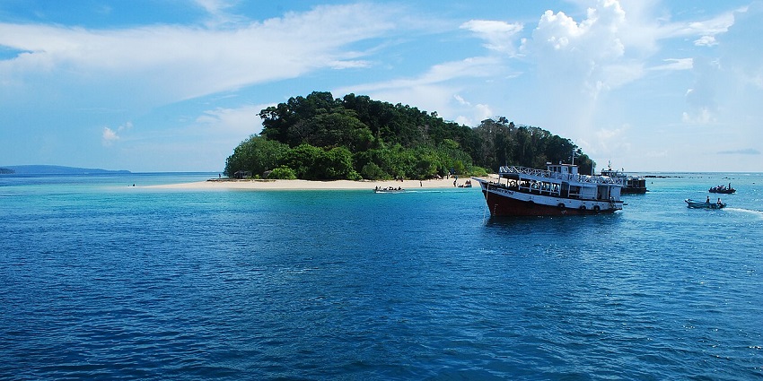 Ships floating deep on blue ocean waters of Mahatma Gandhi Marine National Park, Andaman.
