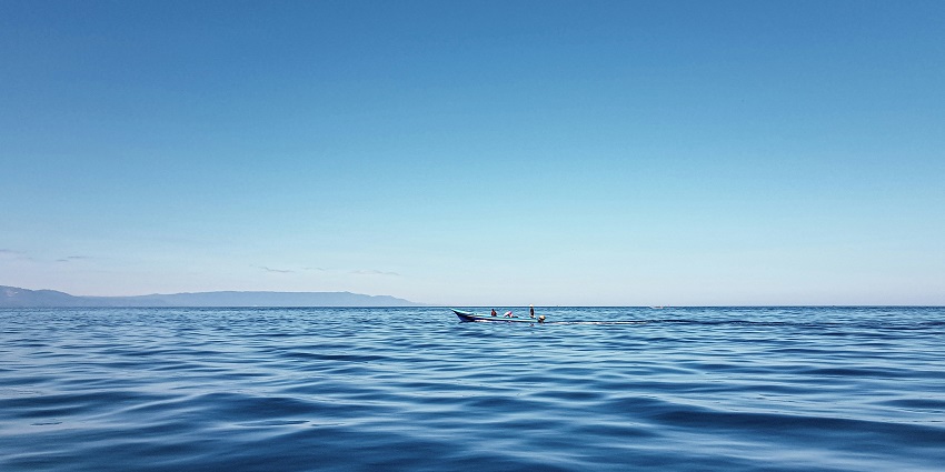 Clear blue waters of Manado with gentle waves and tropical reflections