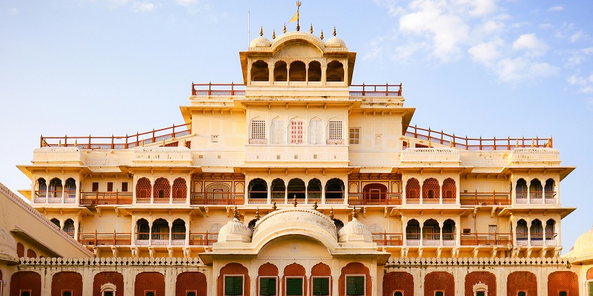 Ornate facade of Chandra Mahal in Jaipur with intricate windows and royal Rajasthani design
