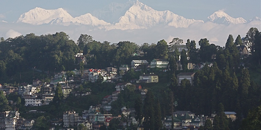 Spring in Darjeeling with blooming hillsides, clear skies, and Himalayan mountain views.
