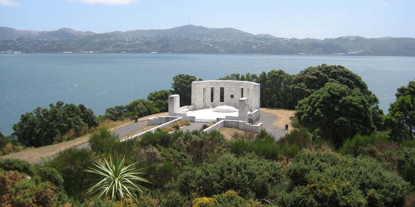 Massey Memorial, surrounded by greenery and overlooking a serene bay, is one of the peaceful war memorial monuments in New Zealand.