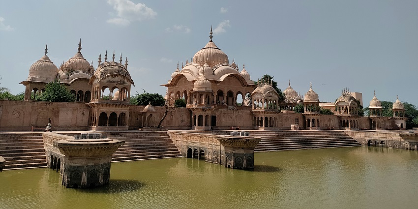 View of a historical building in Mathura by the water, offering a glimpse into the region's rich history
