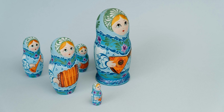 An image of two colourful ceramic Matryoshka dolls figurines displayed on a surface.