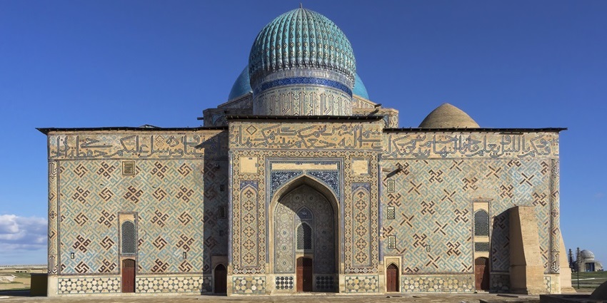 The Mausoleum of Khoja Ahmed Yasawi, with traditional Islamic architecture and scriptures on the wall, is one of the historical places in Kazakhstan.