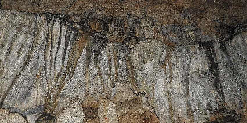 Inside the Mawsmai Cave with unique limestone formations and walls of rocks in Meghalaya.