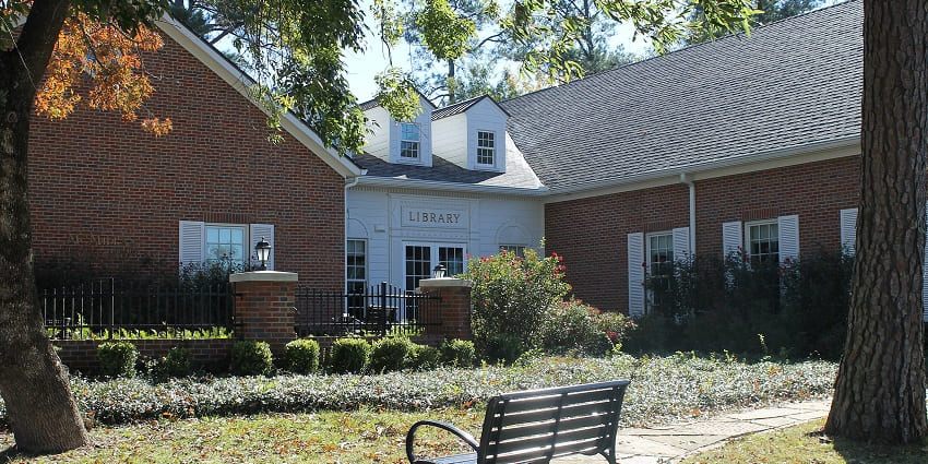 McMillan Memorial Library in Overton, Kenya, with a sitting table in front of the building.