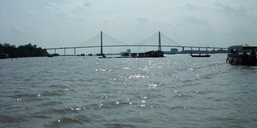 Bridge over the Mekong Delta, Vietnam, Cau Rach Mieu with the river and boats below.