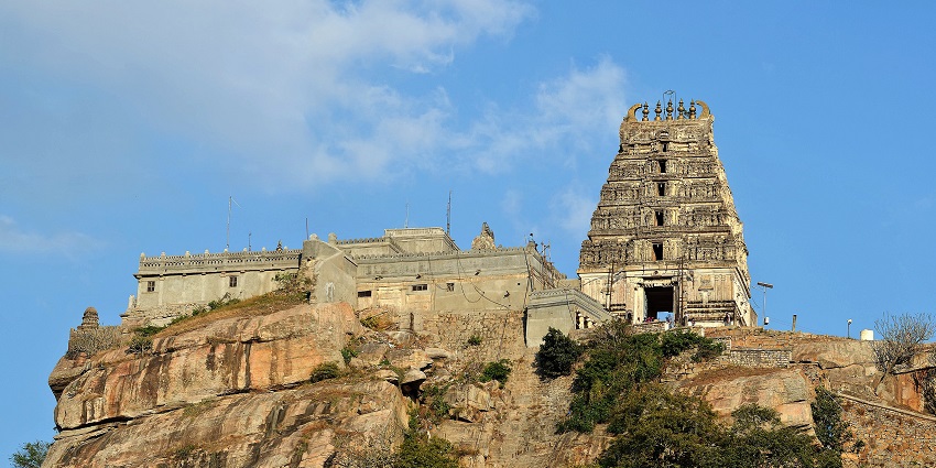 Ancient hilltop temple with detailed gopuram tower, stone walls, one of the best places to visit in Karnataka in November.