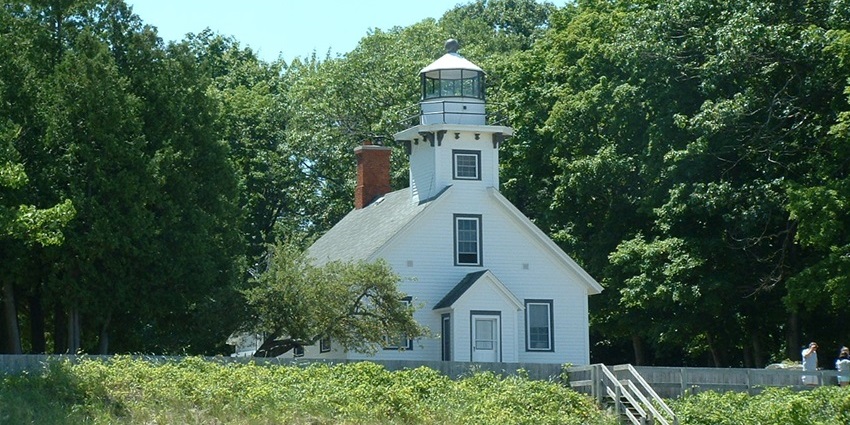 Mission Point Lighthouse in Traverse City, with a white architectural building and a staircase